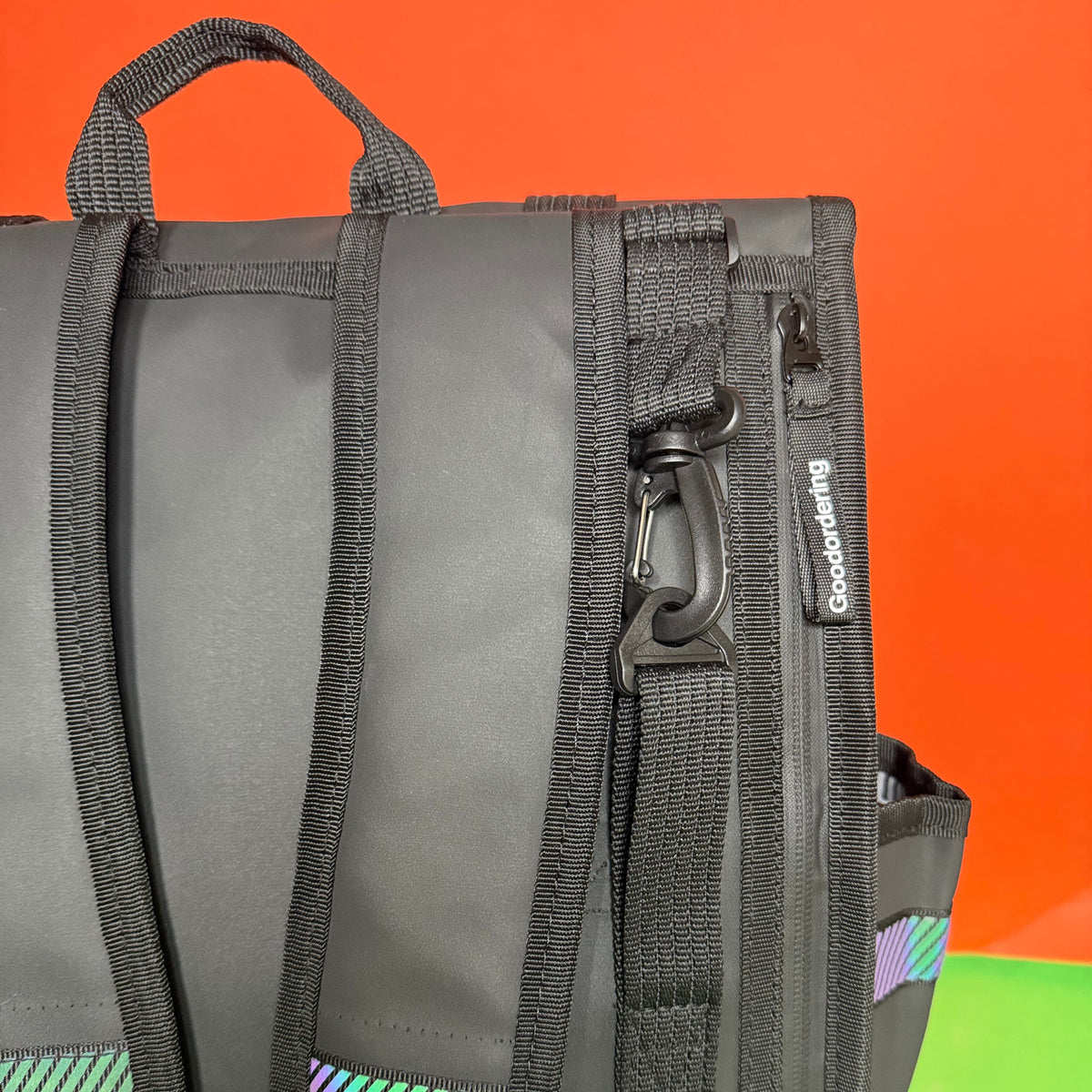 Black waterproof bag with a handle and zippers laptop compartment detail 1. Expandable black rolltop backpack showing rolled and unrolled capacity