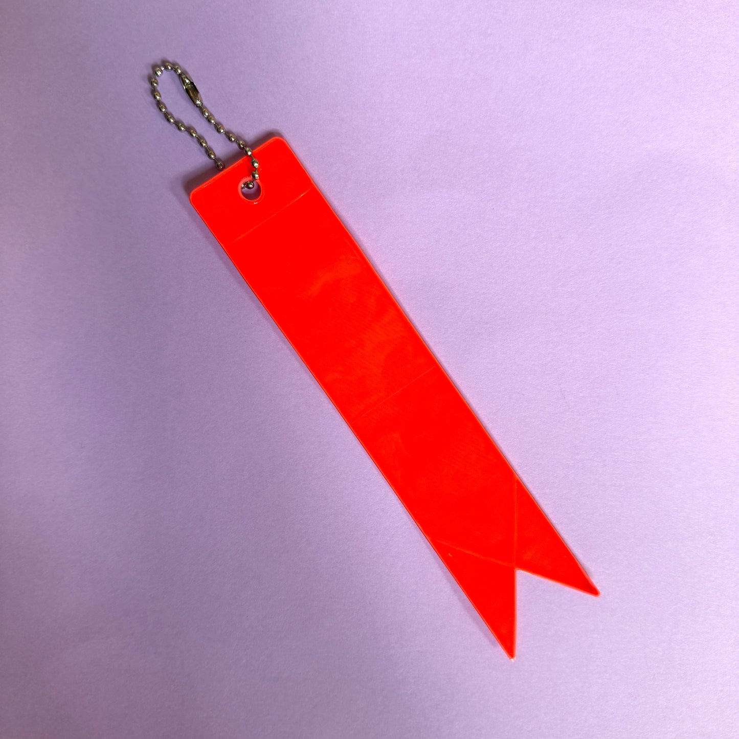 Neon orange light reflector charm