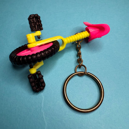 Neon 80s mini unicycle charm keyring