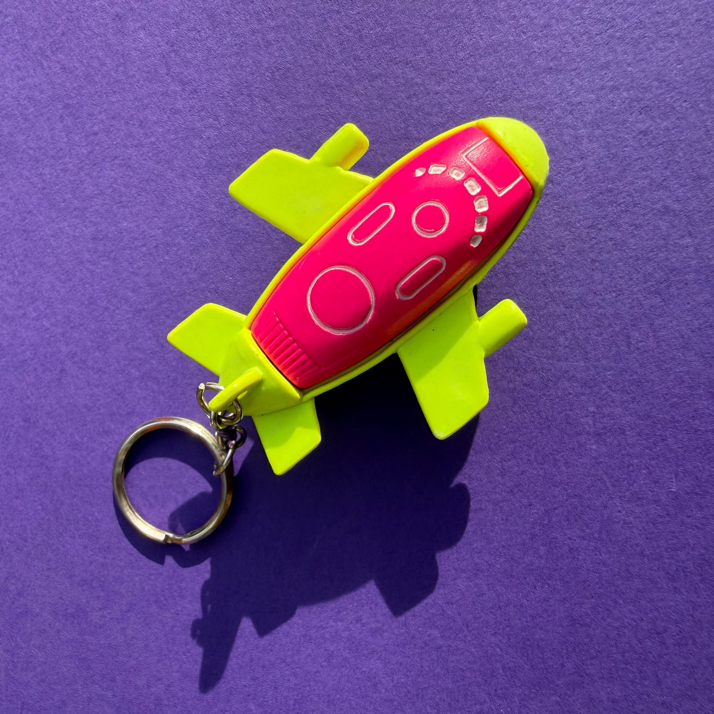 Neon retro 80s keyring plane