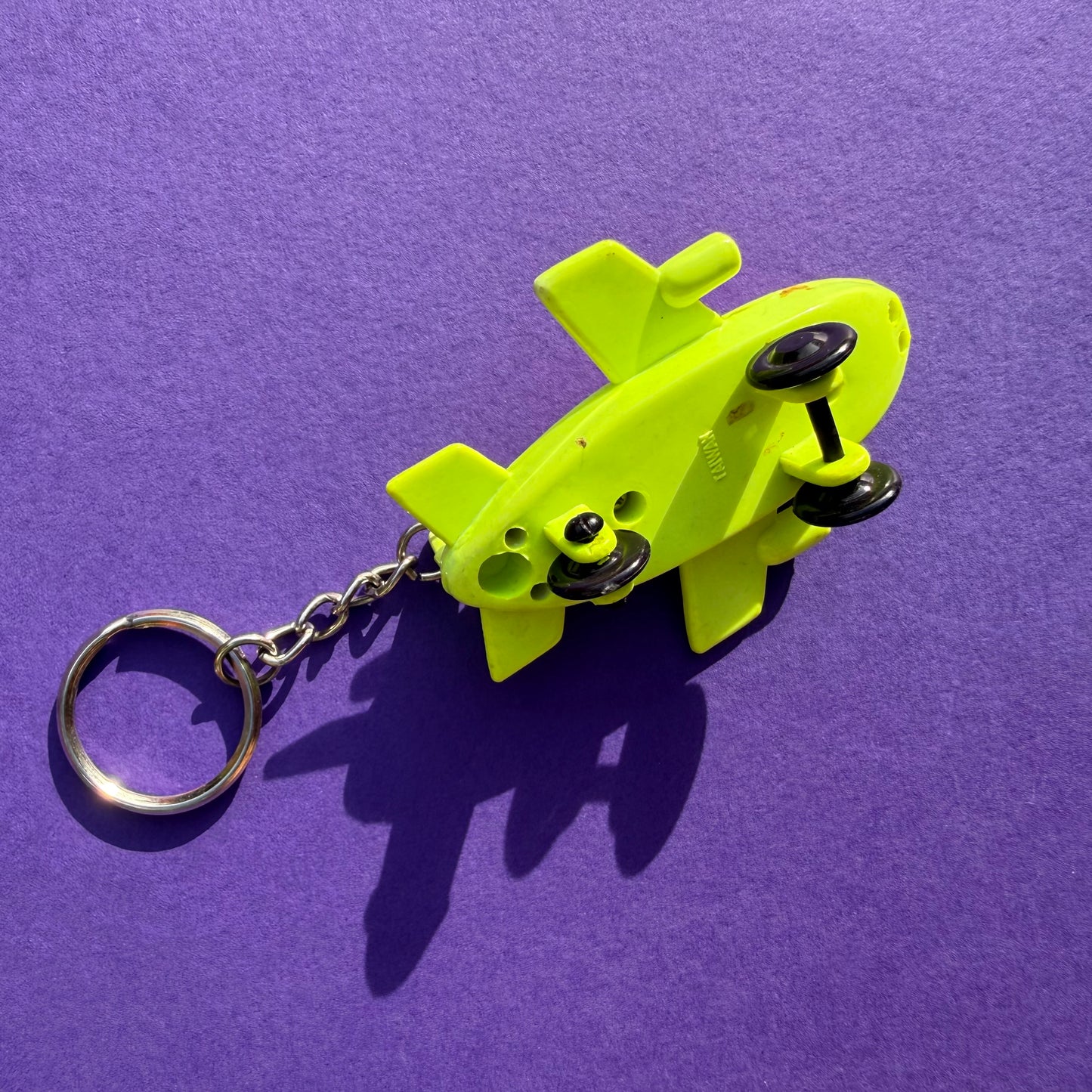 Neon retro 80s keyring plane