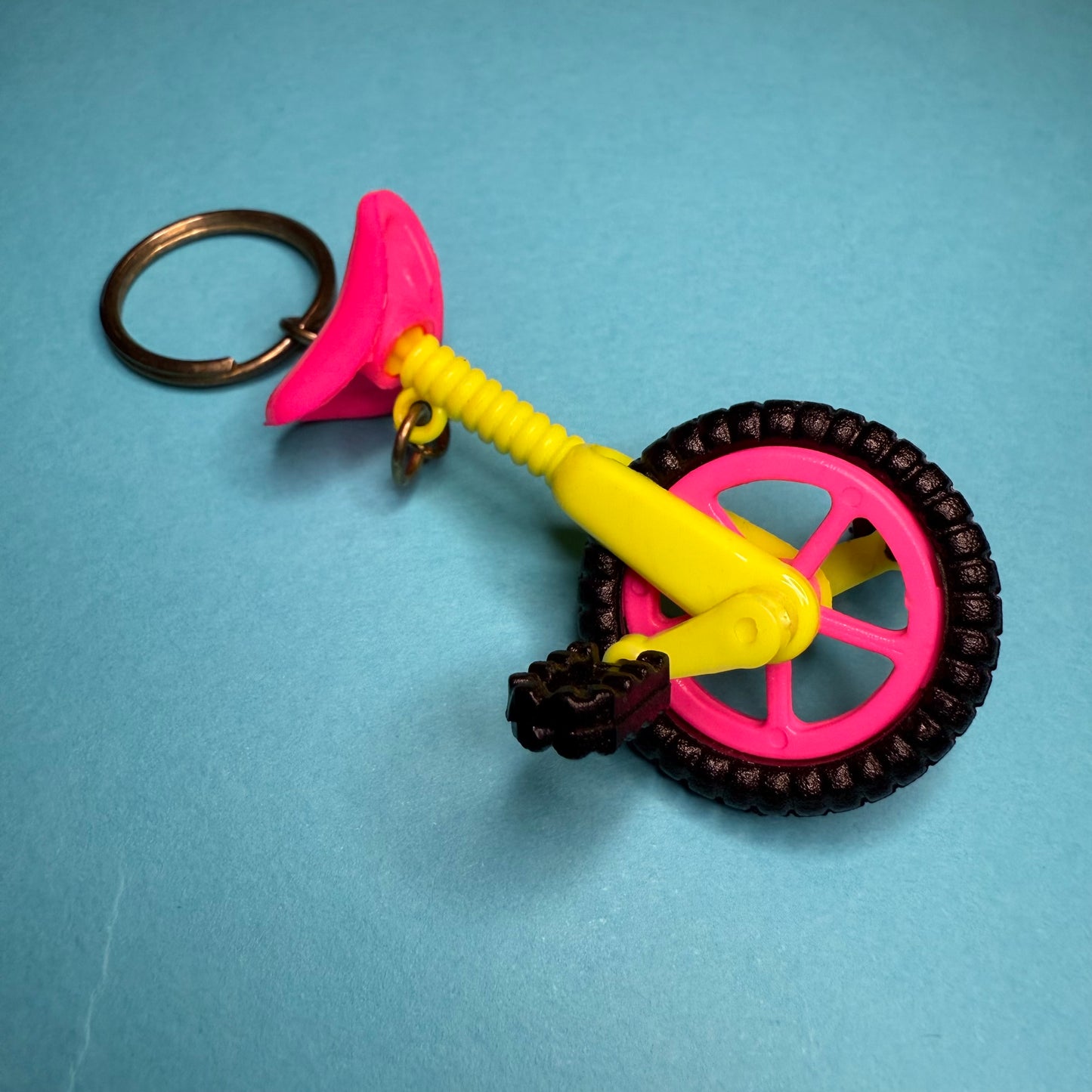 Neon 80s mini unicycle charm keyring