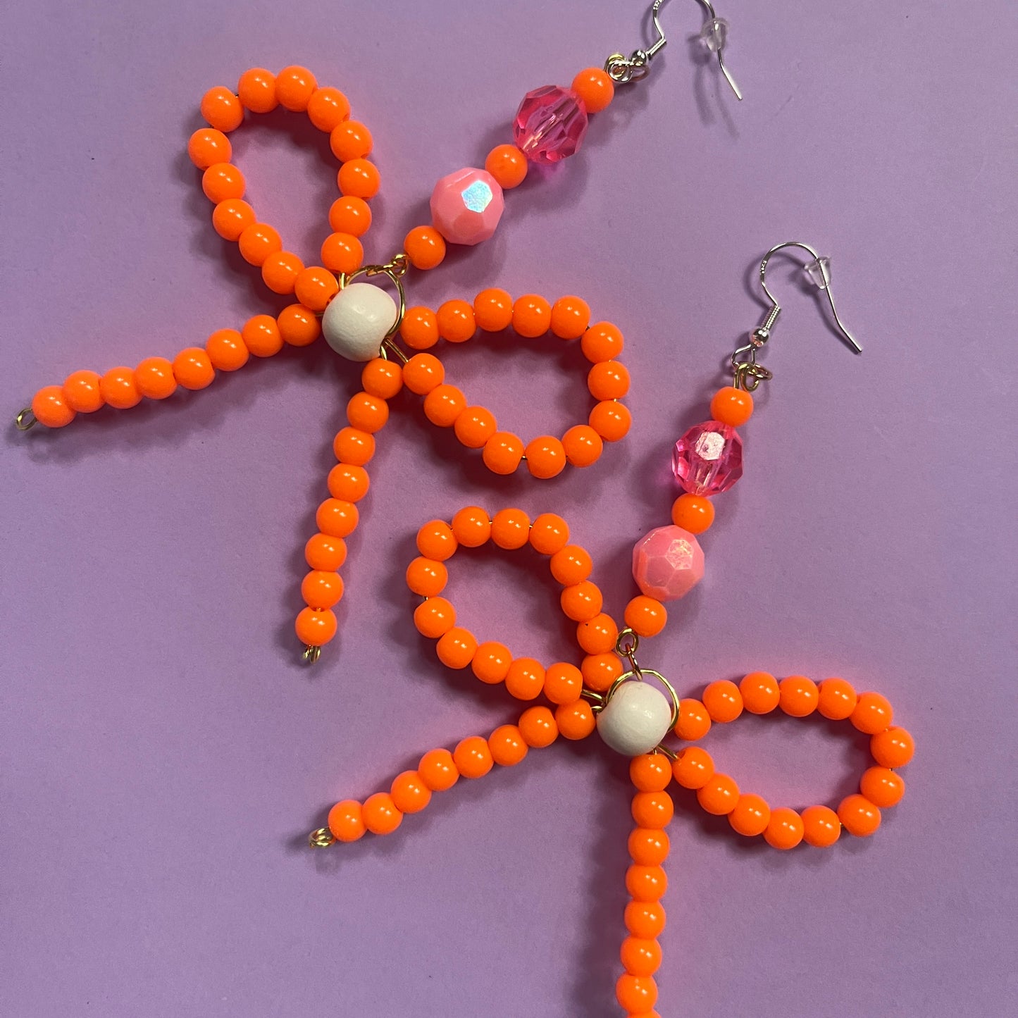 Orange beaded bow earrings