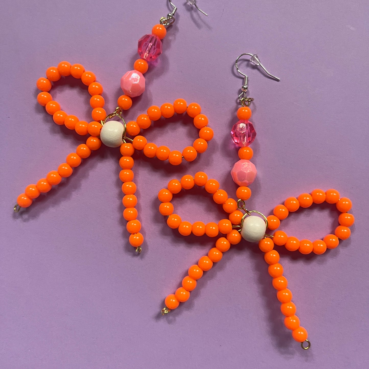 Orange beaded bow earrings