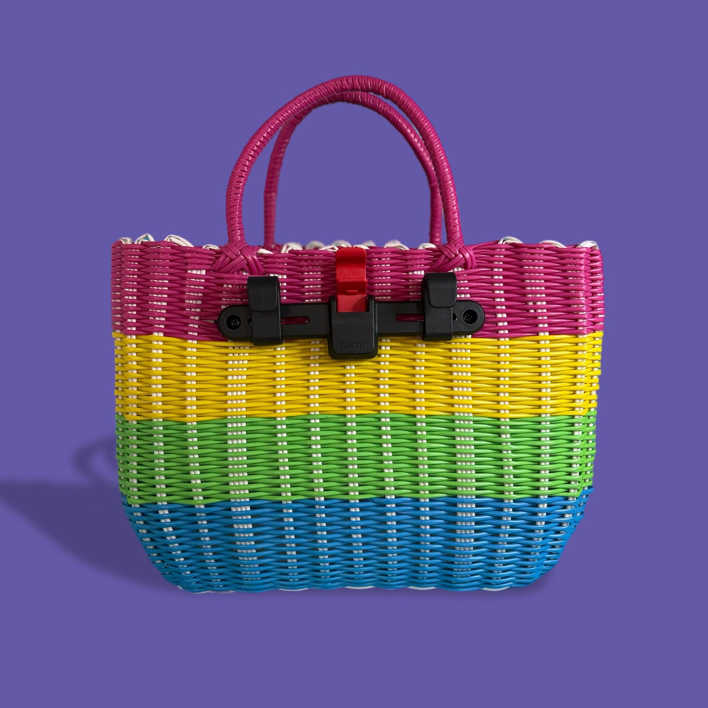 Colorful woven handbag with a black buckle on a purple background