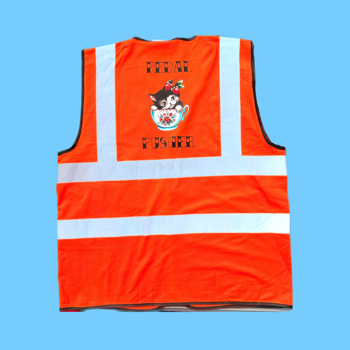 An orange high-visibility safety vest with reflective white stripes, featuring a cartoon cat in a teacup graphic and the text 'FEDAL FUGHER' printed on the back, set against a solid light blue background.
