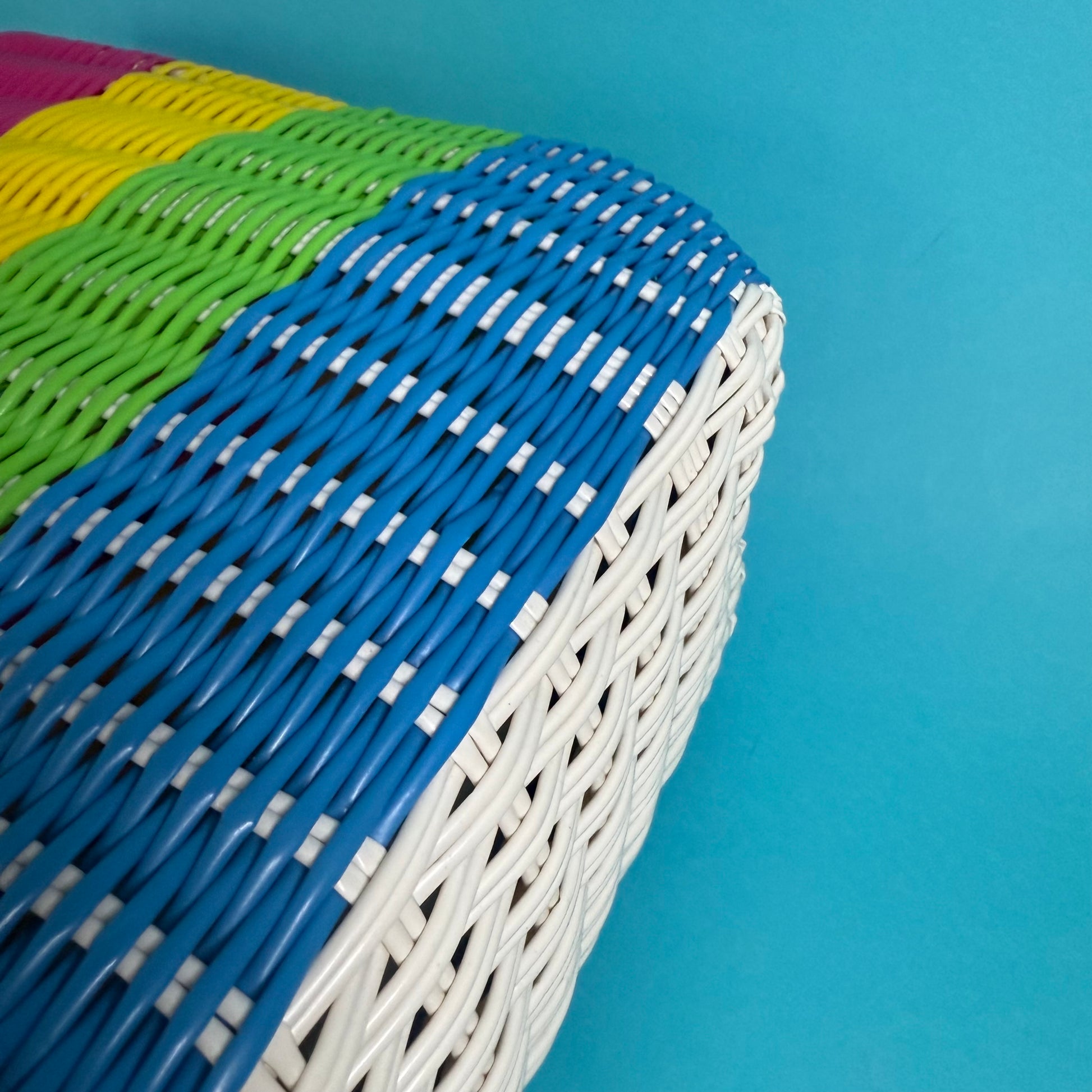 Colorful woven basket with a blue background