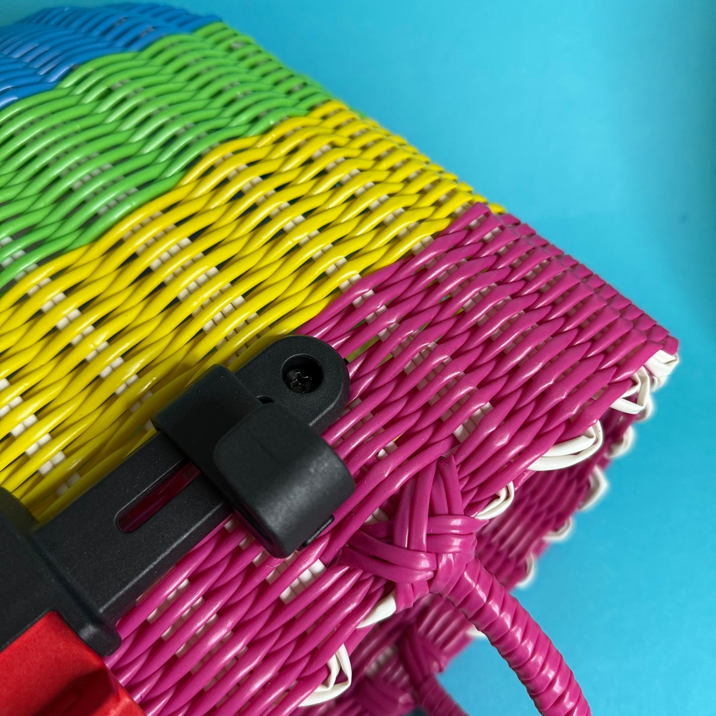 Colorful braided cable with a black connector on a blue background