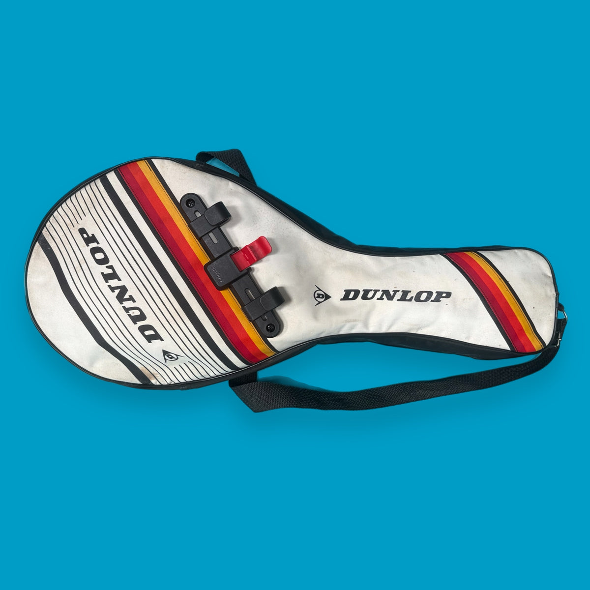 Dunlop tennis racket cover with colorful stripes on a blue background upcycled bike bag