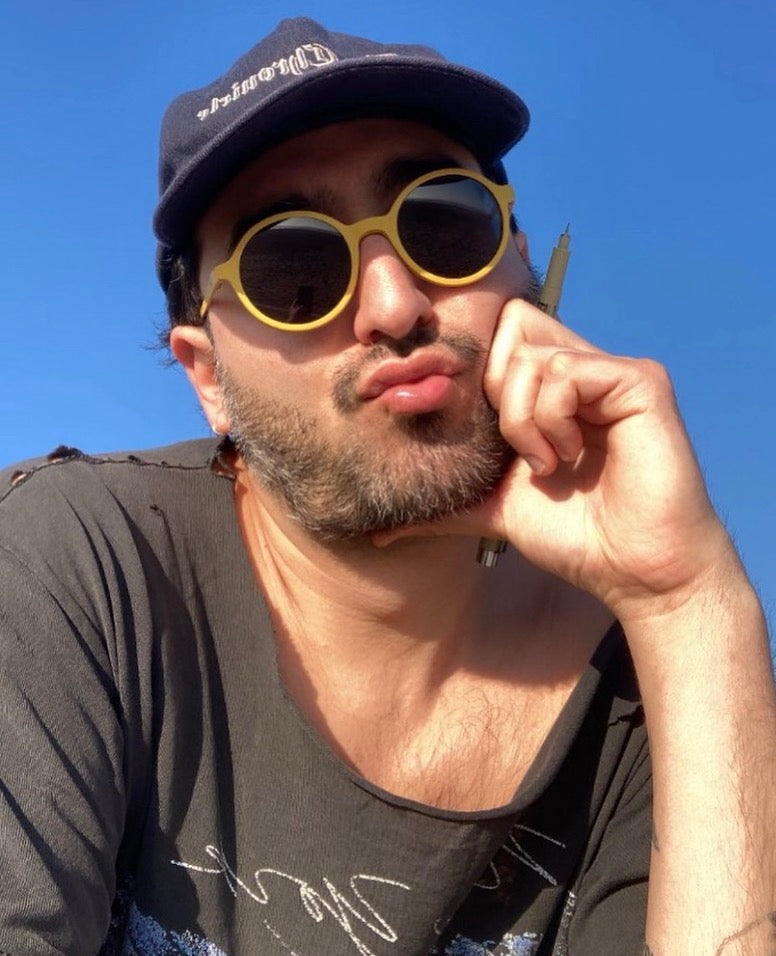 A man wearing round yellow-framed sunglasses, a dark navy baseball cap transformable magnetic glasses goodordering