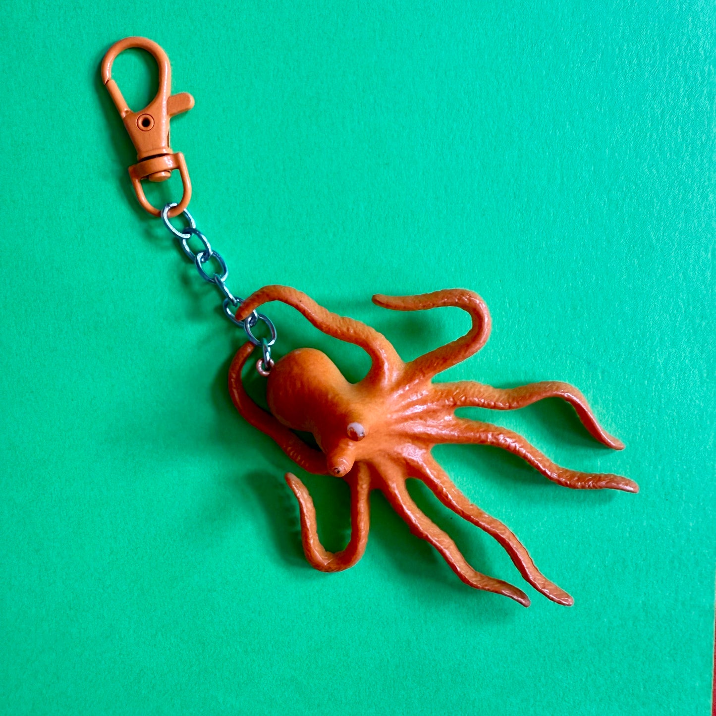 Octopus keychain on a green background