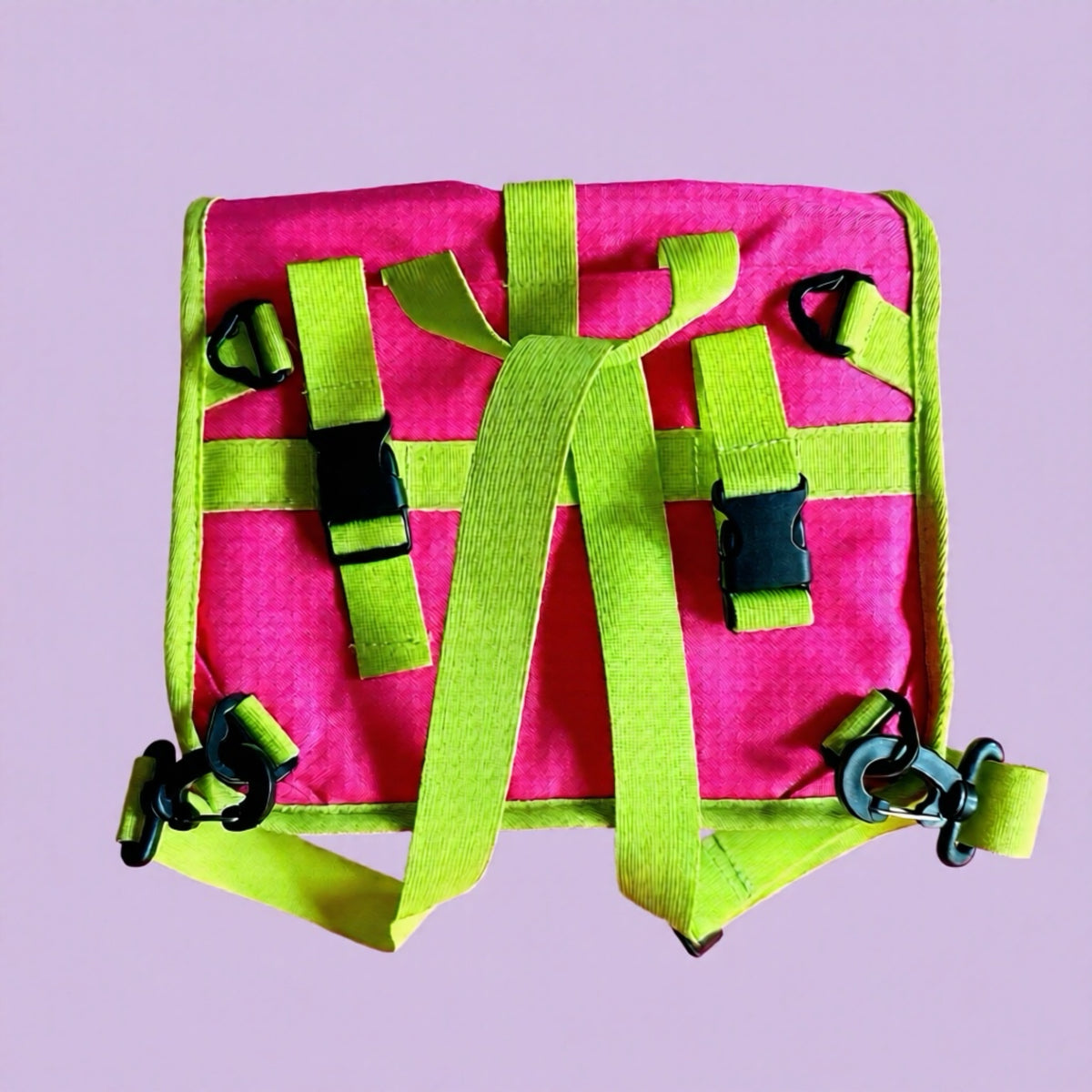 Pink and neon yellow green cycling handlebar bag on a purple background