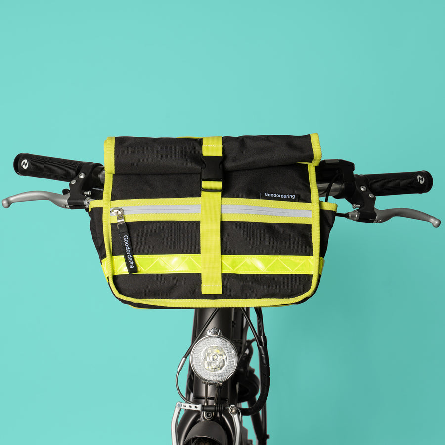 Goodordering black shoulder bag with neon yellow edging on bicycle handlebars
